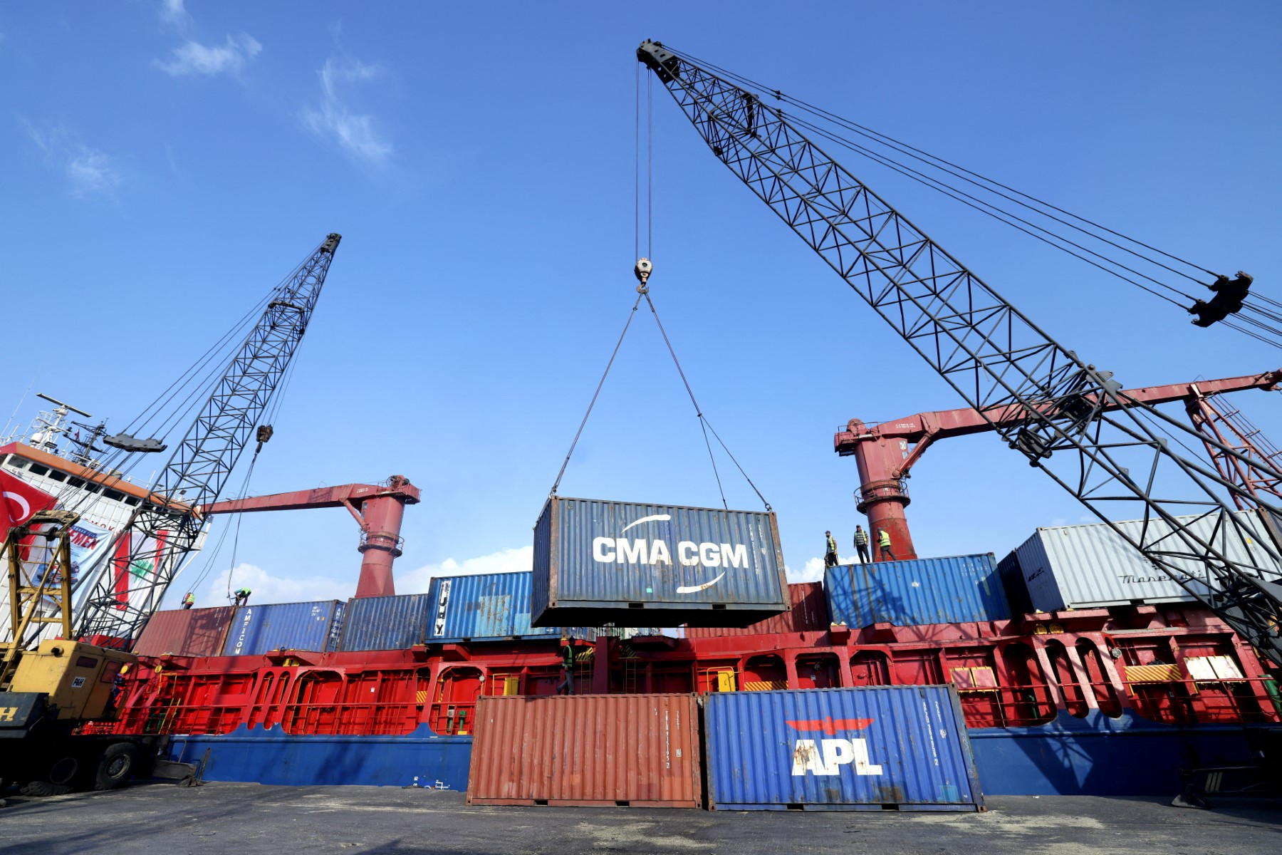 Above, containers being unloaded from a ship docked at Beirut Port on Nov. 1, 2024. (AFP file photo)