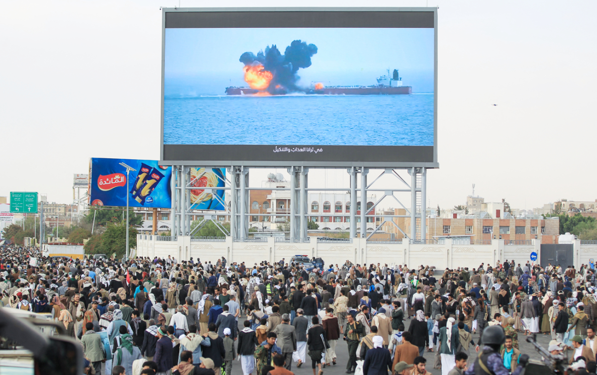 Images of a fireball exploding on a cargo ship are shown on a giant screen during a protest called for by Yemen's rebel Huthi movement in Sanaa on March 17, 2025. (AFP)