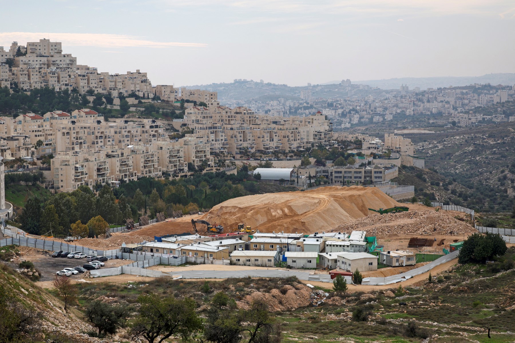 A picture shows a general view of the Israeli settlement of Har Homa in the Israel-annexed East Jerusalem on December 7, 2023 with the West Bank city of Bethlehem in the background (R). (AFP)