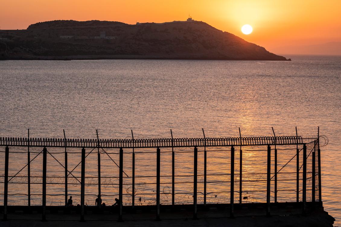Moroccan men fish on the Moroccan side of the border with Spain, as seen from the district of Benzu in the Spanish enclave of Ceuta, Jun. 3, 2021. (AP / File)