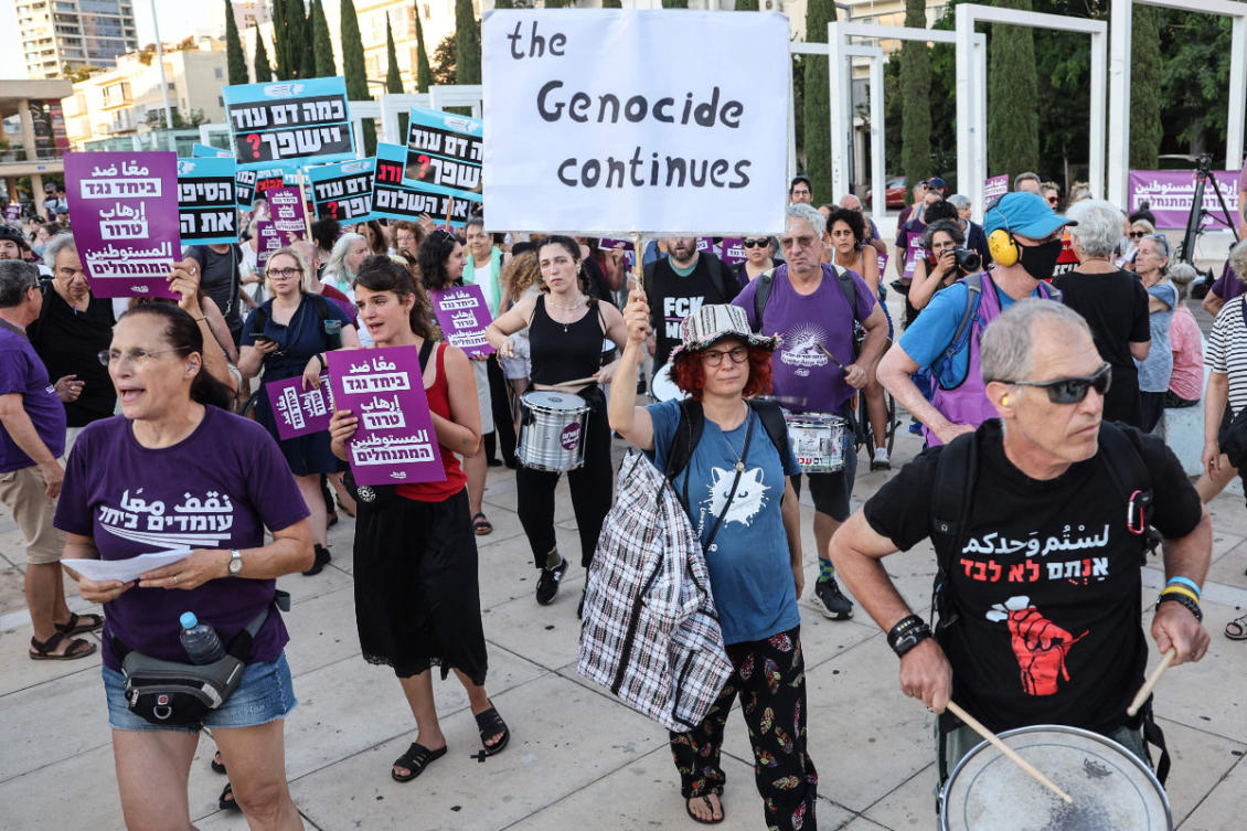 Activists hold placards during a demonstration in Tel Aviv on July 28, 2026, against recent violent attacks by Israeli settlers in the Israeli-occupied West Bank. (AFP)