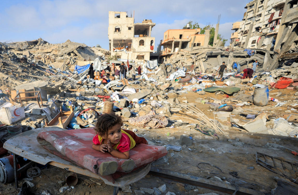 A Palestinian girl child lies on a damaged mattress at the site of Wednesday's Israeli strike on a house whose residents were pre-warned by the Israeli military to evacuate, in Gaza City. (Reuters)