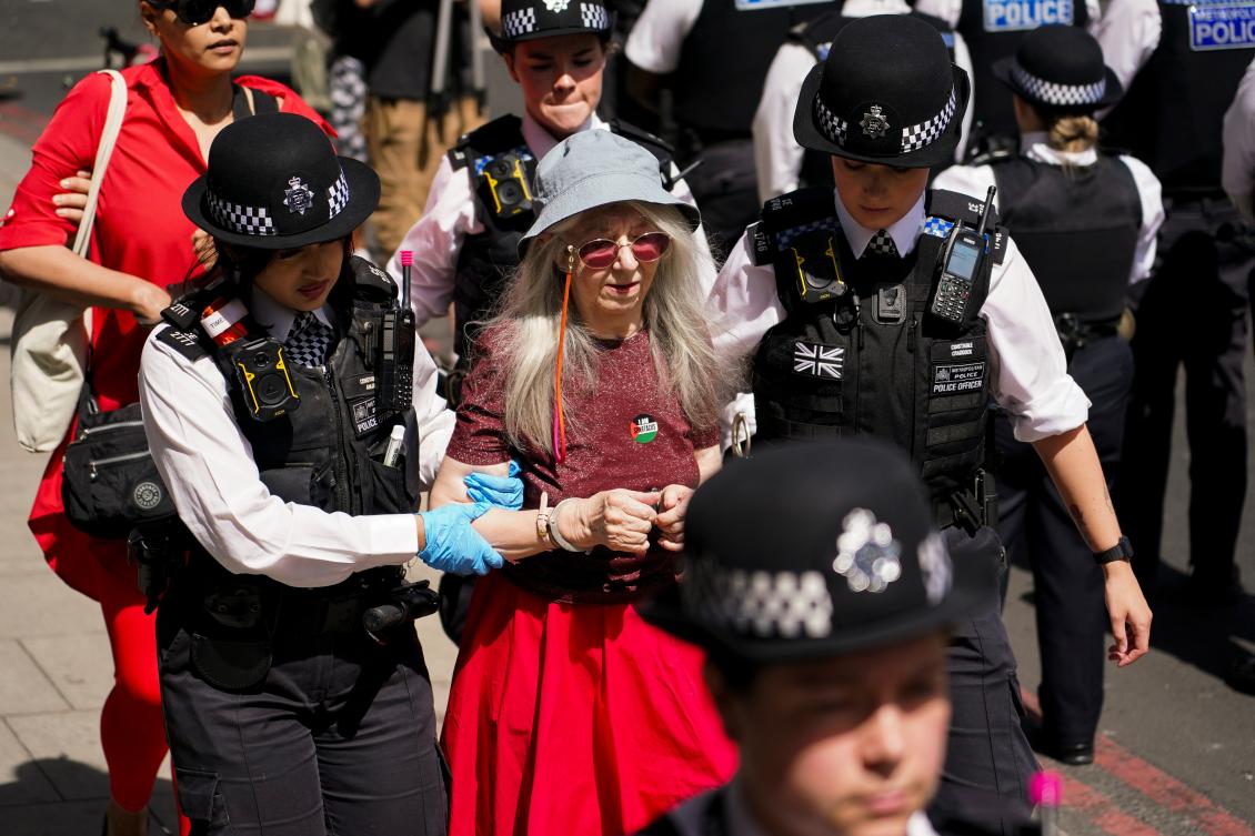 A demonstrator is arrested by the police outside the Westminster Magistrates Court in London, Thursday, July 30, 2026, as a plea hearing for 25 people accused of showing support for Palestine Action takes place. (AP)