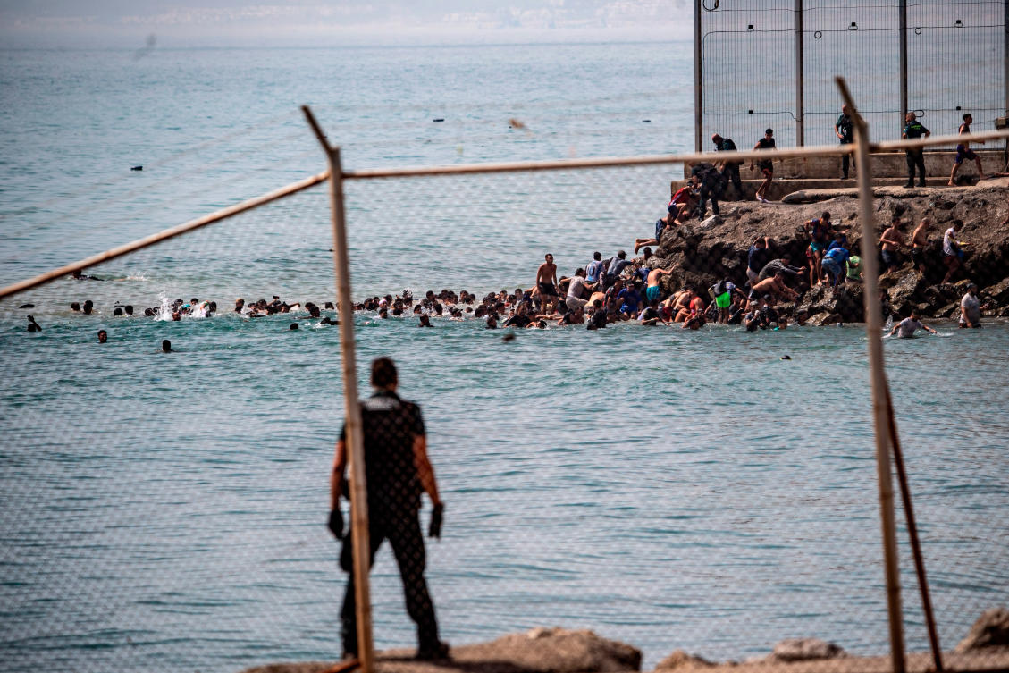 Migrants cross from Morocco into the Spanish enclave of Ceuta, Thursday, July 30, 2026. (AP Photo/Antonio Sempere)