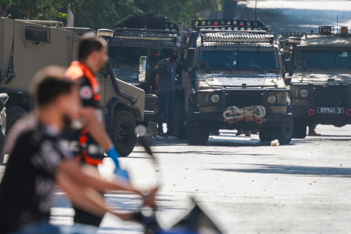 Israeli soldiers detain a man as they surround the Nablus Specialized Hospital, where they allegedly arrested a wounded man and his brother from inside the hospital in Nablus, in the Israeli-occupied West Bank, Jul. 24, 2026. (AFP)