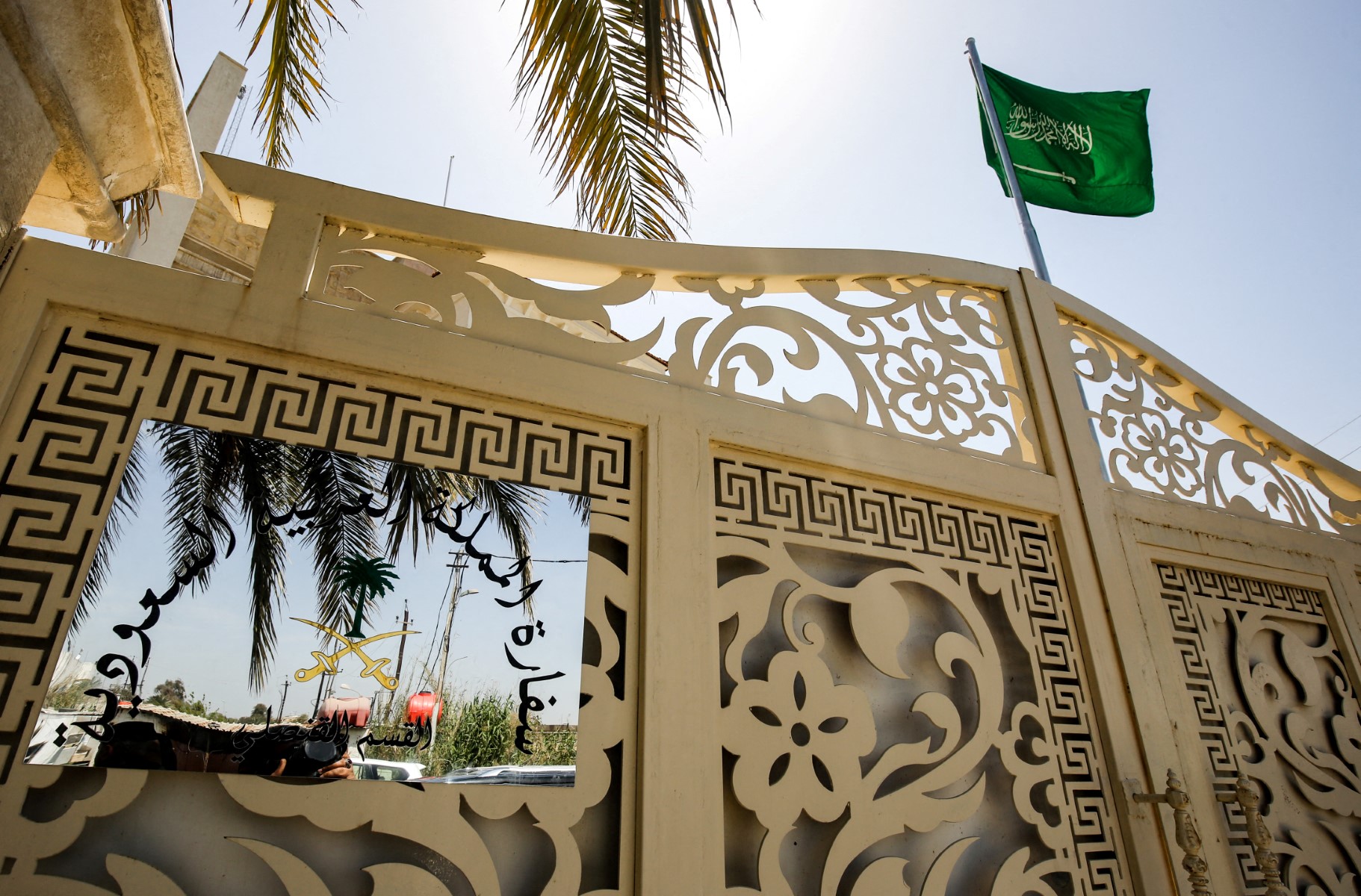 Above, a Saudi flag flies over the gatehouse to the new Saudi consulate headquarters in the Iraqi capital Baghdad on April 4, 2019. (AFP file photo)