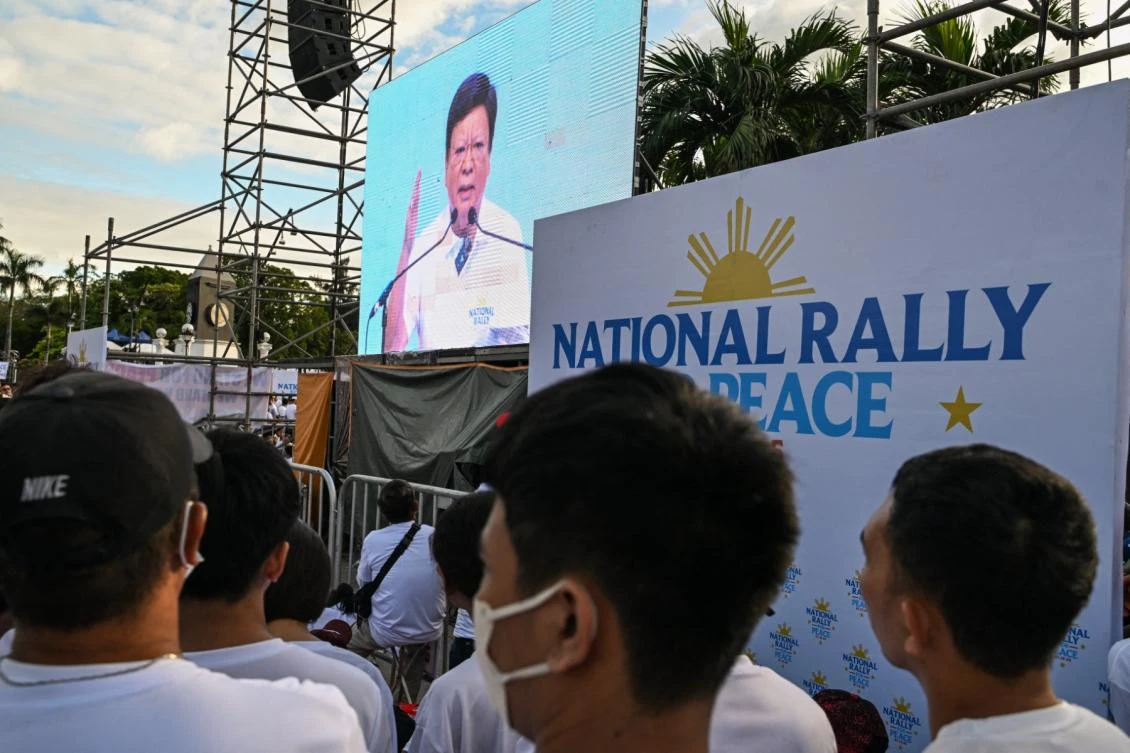 Above, members of the influential sect Iglesia ni Cristo watch Philippine lawmaker Rodante Marcoleta speak as they attend a rally to oppose calls to unseat Vice-President Sara Duterte in Manila on Jan. 13, 2025. (AFP file photo)