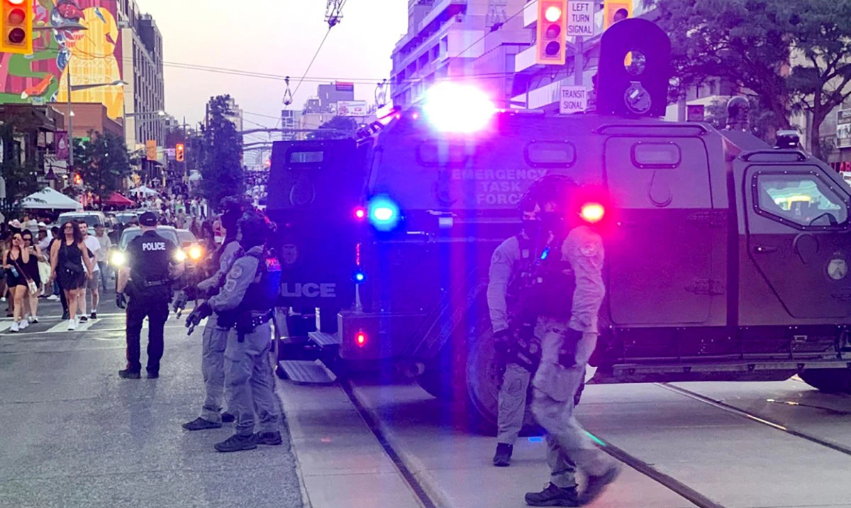 Emergency Task Force vehicles and police officers are seen on the site of a shooting in Toronto, Canada on July 11, 2026. (AFP)