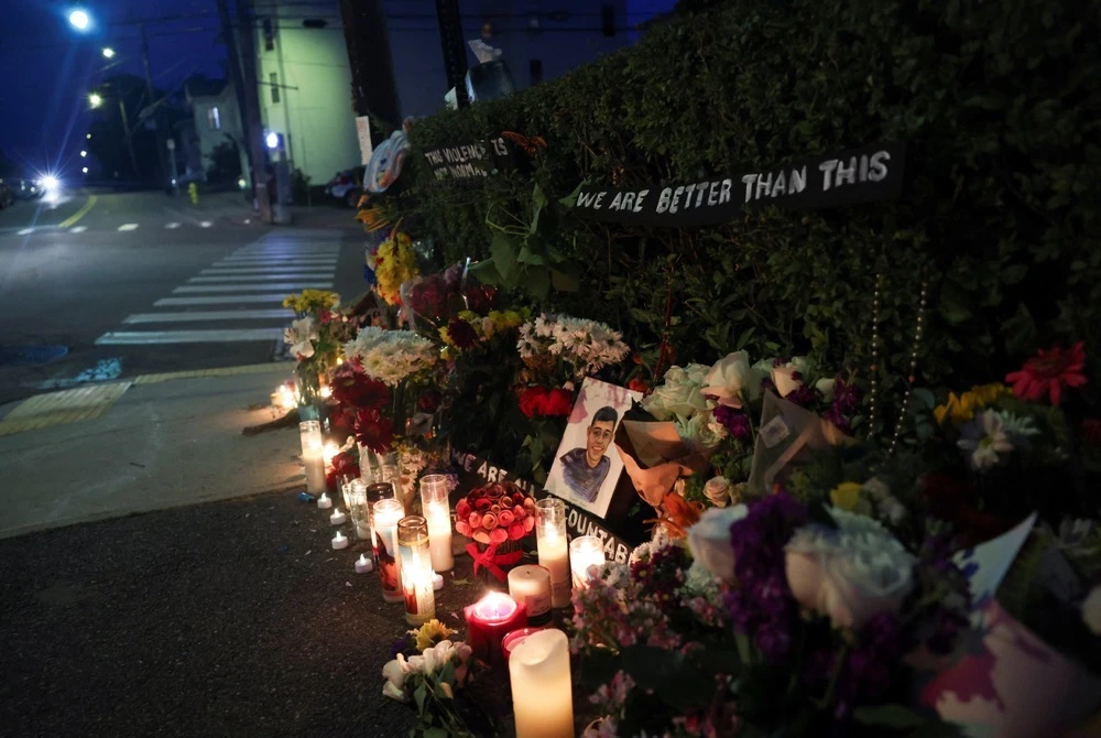 Flowers and a portrait with writing that reads “Joan Sebastian Guerrero” sit at a makeshift street-side memorial, a day after US Immigration and Customs Enforcement (ICE) agents fatally shot a driver, in Biddeford, Maine, U.S., July 14, 2026. (Reuters)