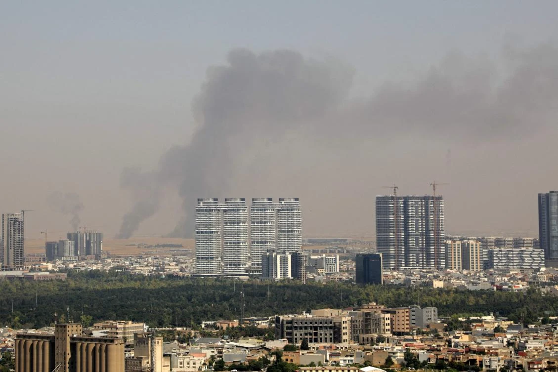 Smoke rises after explosions were heard and air defences activated near the airport in Irbil, northern Iraq, on Friday. (AFP)
