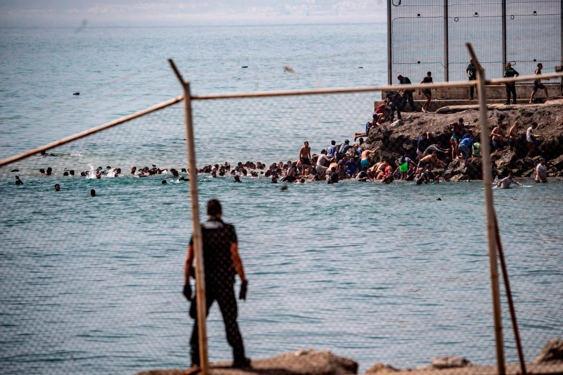 Migrants cross from Morocco into the Spanish enclave of Ceuta, Thursday, July 30, 2026. (AP Photo/Antonio Sempere)