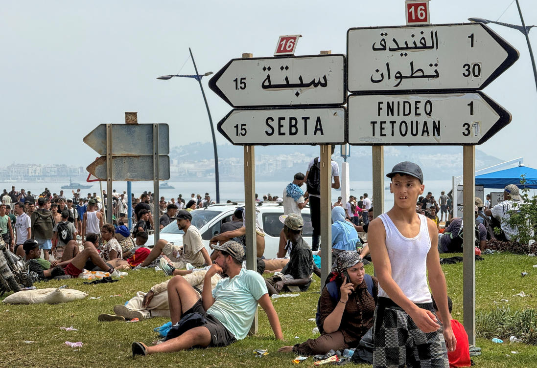 Migrants rest after crossing back from the Spanish enclave of Ceuta, to the Moroccan side of the border in Fnideq, Morocco. (Reuters)