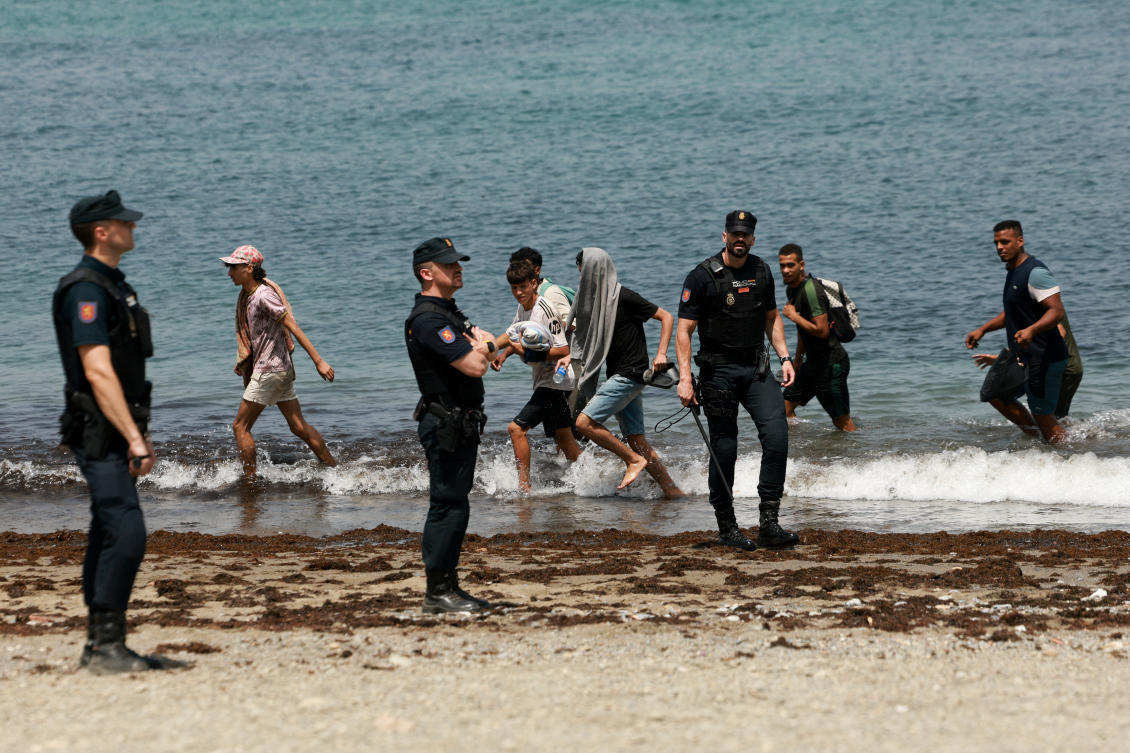 Migrants try to make their way past Spanish police officers, following recent mass crossings of migrants on foot and by sea from Morocco into Spanish territory, in Ceuta, Spain. (Reuters)