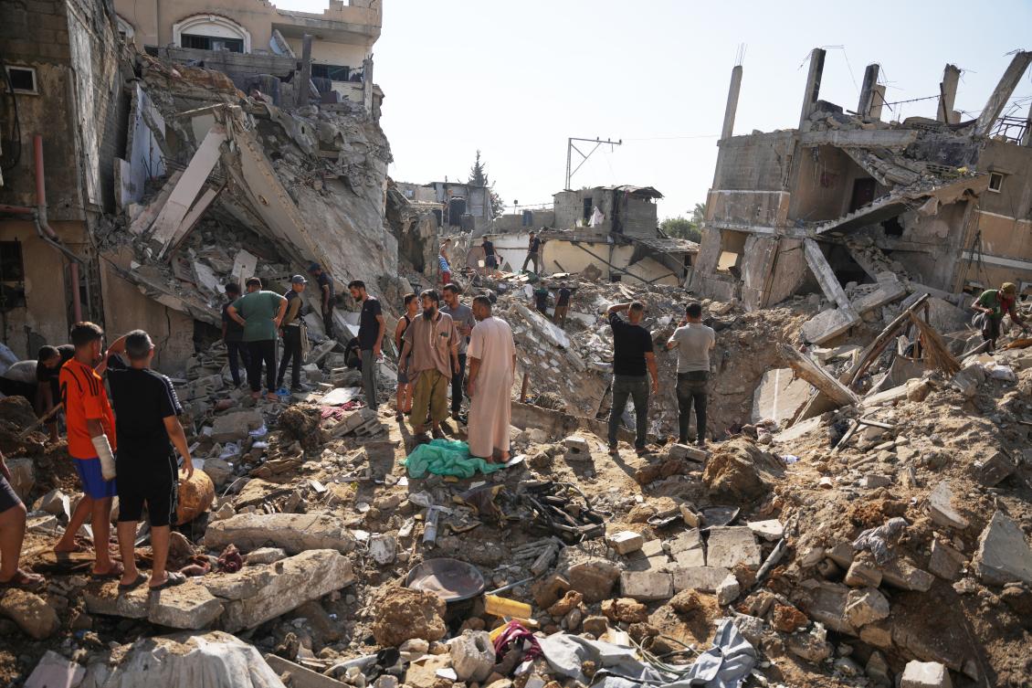 Palestinians inspect destroyed buildings at the scene of an Israeli airstrike, at Al-Maghazi refugee camp, central Gaza Strip, Aug. 1, 2026. (AP)