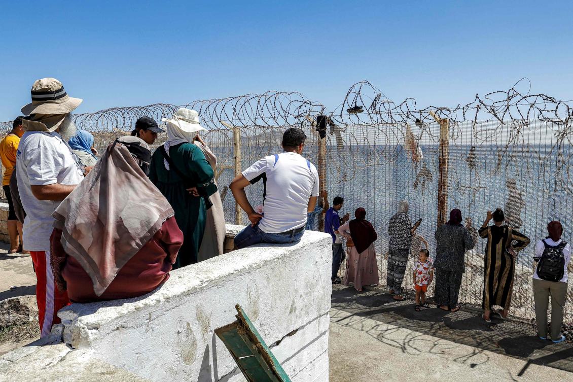 Relatives and friends wait at Morocco’s Bab Sebta crossing for people returning from Spain’s North African enclave of Ceuta on Aug. 2, 2026. (AFP photo)