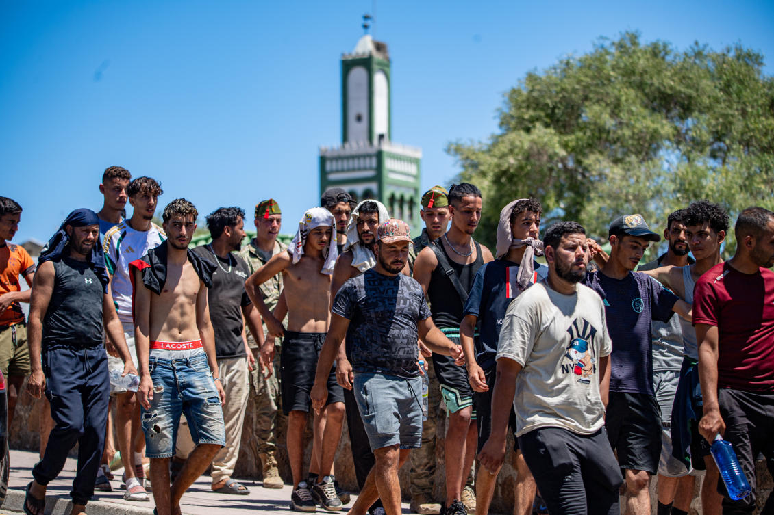 Migrants who crossed into Spain are escorted by Spanish soldiers, not pictured, toward the Spanish-Moroccan border for their return to Morocco. (AP)