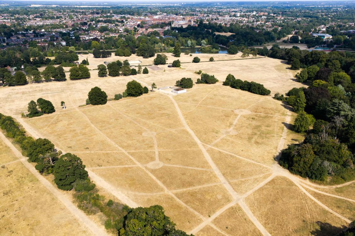 An aerial photograph shows footpaths in the sun scorched grass at Verulamium Park in St Albans, north of London on August 3, 2026. (AFP)