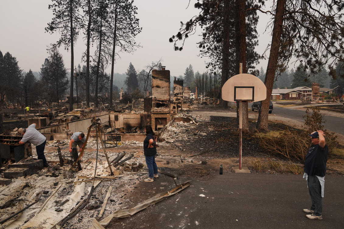 Residents look through the remains of their home after a wildfire hit the northern part of Spokane, Washington on Aug. 3, 2026. (AP)