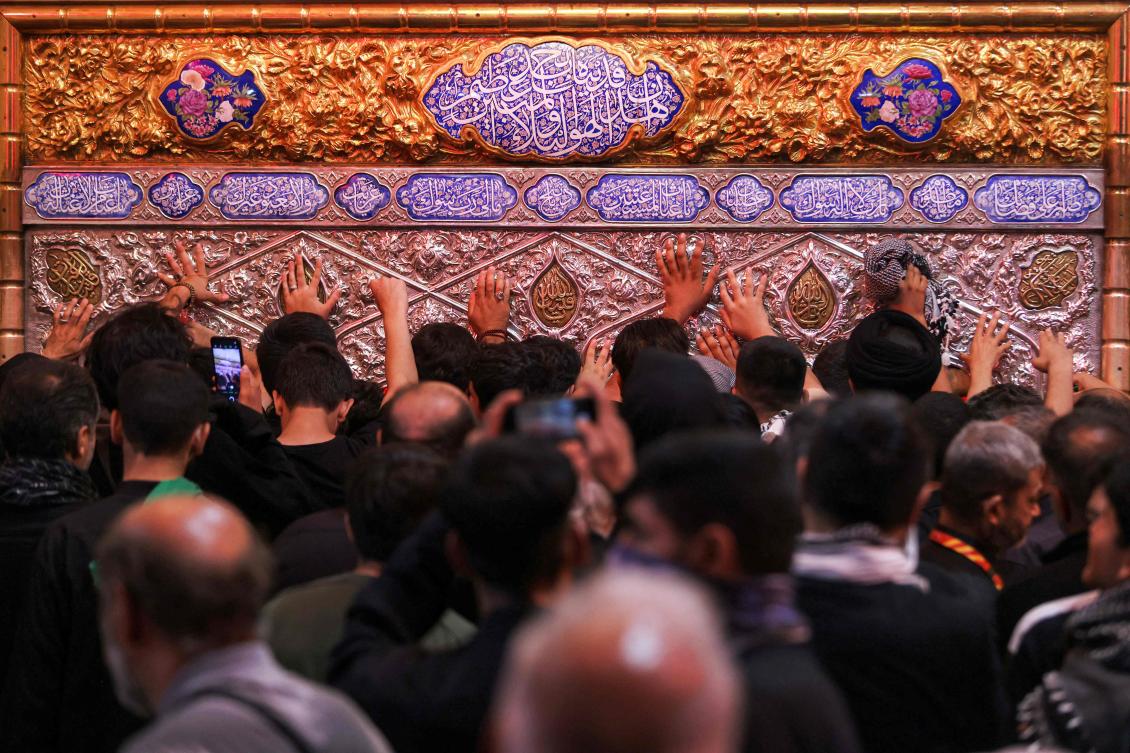 Shia Muslim pilgrims pray at the shrine of Imam Hussein in the city of Karbala, south of Baghdad on August 3, 2026. (AFP)