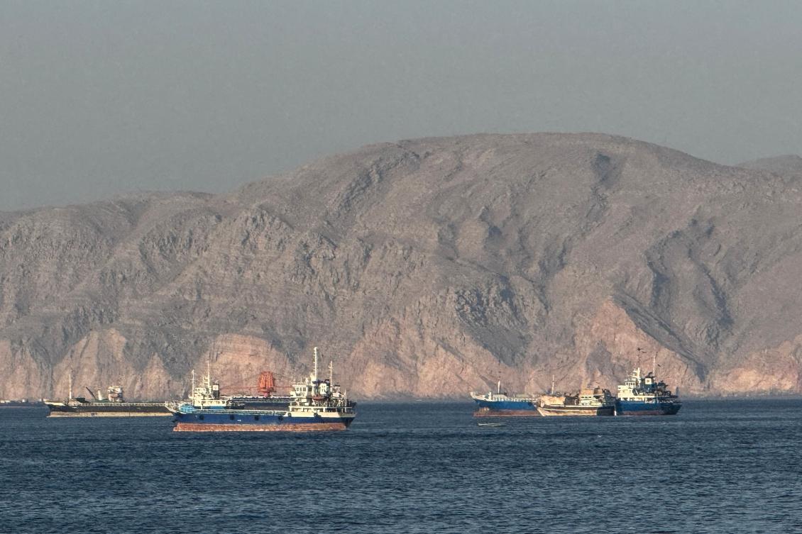 Vessels are seen anchored in the Strait of Hormuz, off the port city of Khasab on Oman’s northern Musandam Peninsula on May 17, 2026. (AFP)