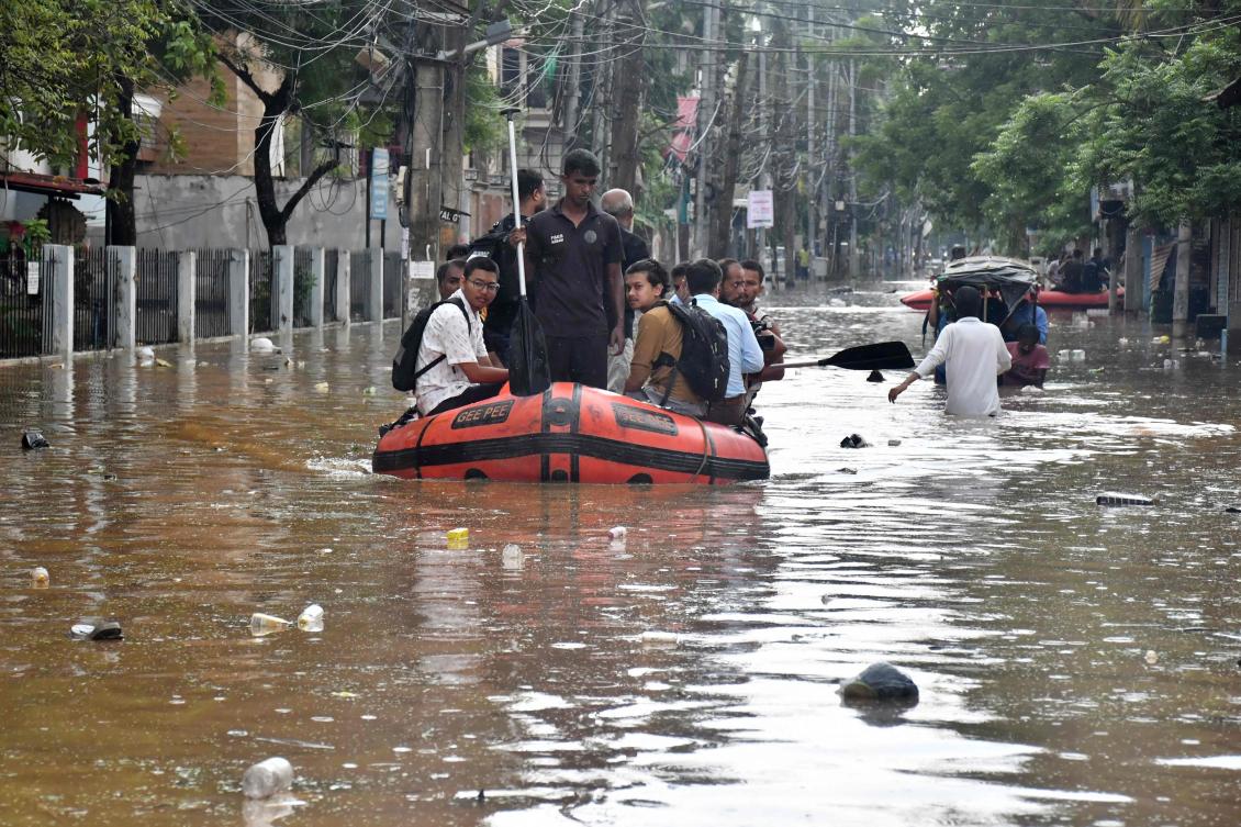 State Disaster Response Fund (SDRF) personnel rescue residents from a flooded area following heavy monsoon rains in Guwahati on August 4, 2026. (Photo by Biju BORO / AFP)