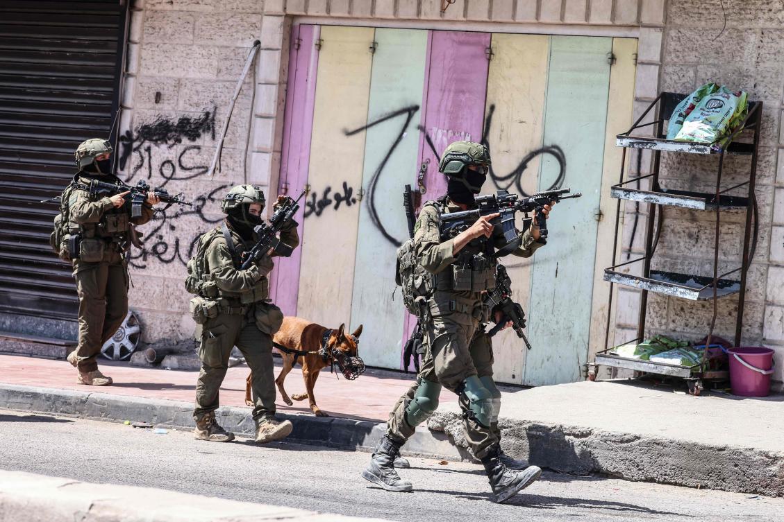 Israeli security forces patrol along a street during a military raid in the Qalandia refugee camp, south of Ramallah in the Israeli-occupied West Bank, on August 5, 2026. (AFP)