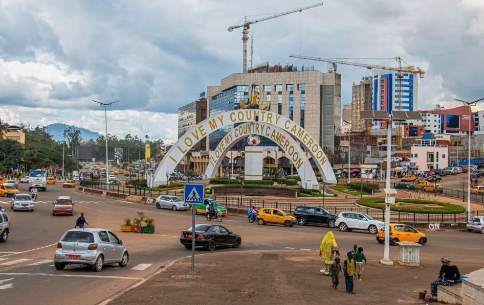 Cars drive through an intersection near a monument in Yaounde, Cameroon, Sept. 12, 2025. (AP Photo)