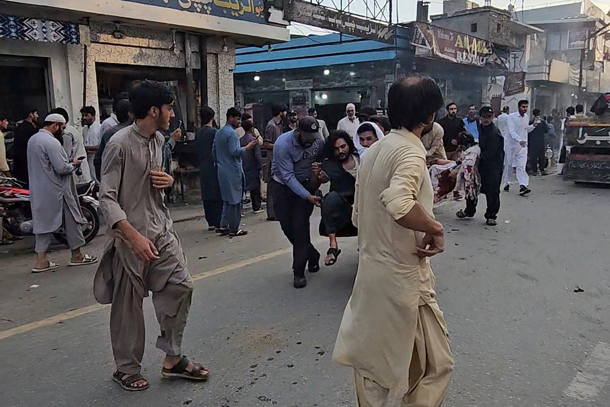 People evacuate injured victims following a suicide bombing during a protest in Pakistan's Swat district on August 2, 2026. (AFP)