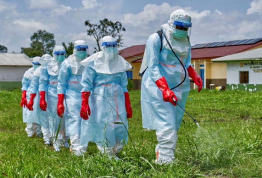 Red Cross workers walk in a formation as they disinfect Rwampara general hospital before handling the body of a person who died of Ebola, as aid agencies intensify efforts to contain a new Ebola outbreak involving the Bundibugyo strain, in Rwampara outside Bunia, Ituri province, DR Congo, May 21, 2026. (Reuters)