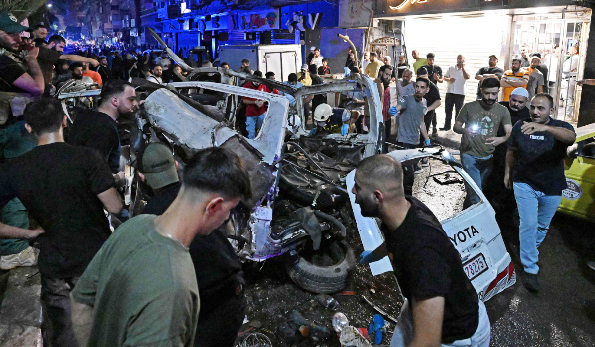 Rescuers and onlookers inspect the wreckage of a minibus at the site of a blast near Damascus August 6, 2026. (AFP)