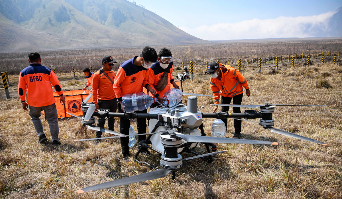 Officials from the East Java Provincial Disaster Management Agency fill a droneís water tank to battle a wildfire in the Bromo Tengger Semeru National Park near Mount Bromo in Probolinggo, East Java province on August 6, 2026. (AFP)