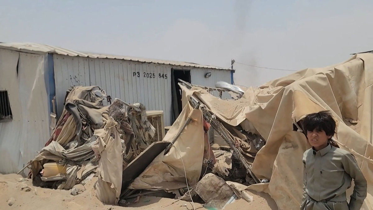 This frame grab taken from AFPTV video footage on August 7, 2026, shows a boy standing near the damage at Mail al-Saila internally displaced camp (IDP) on the outskirts of Marib following a Houthi ballistic missile attack on the government-held city of Marib early August 7. (Photo by AFPTV / AFP)
