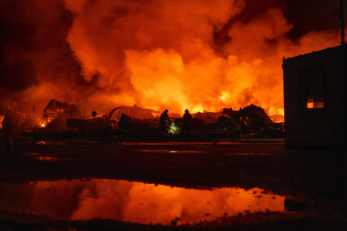 Firefighters put out a fire after Russian missiles hit a warehouse in Kyiv, Ukraine, Wednesday, Aug. 5, 2026. (AP Photo/Dan Bashakov)