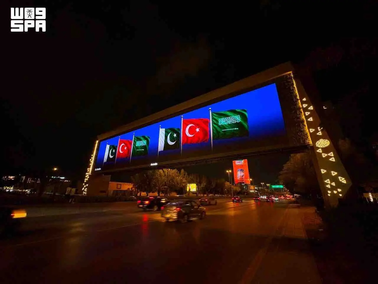 Saudi landmarks glow with three flags