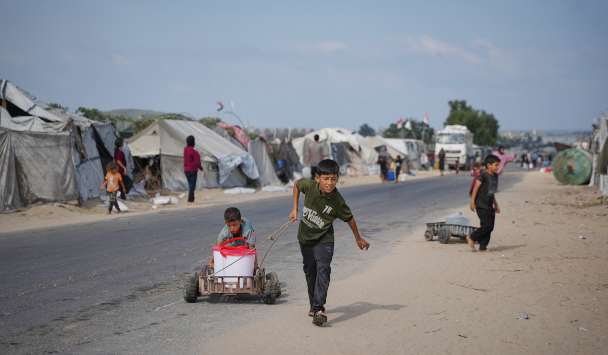 Palestinian boys pull a cart carrying water containers at a makeshift camp for displaced people in Deir al-Balah, central Gaza Strip, Friday, Aug. 7, 2026. (AP)