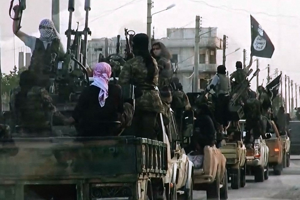 An image grab taken from a propaganda video released on March 17, 2014 by the Daesh (Islamic State of Iraq and the Levant's al-Furqan Media shows Daesh fighters driving on a street in the northern Syrian City of Homs. (AFP file photo)