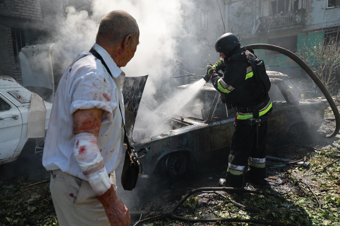 Rescue workers try to put out a fire after a Russian air guided bomb strike in Zaporizhzhia, Ukraine on Monday. (AP)