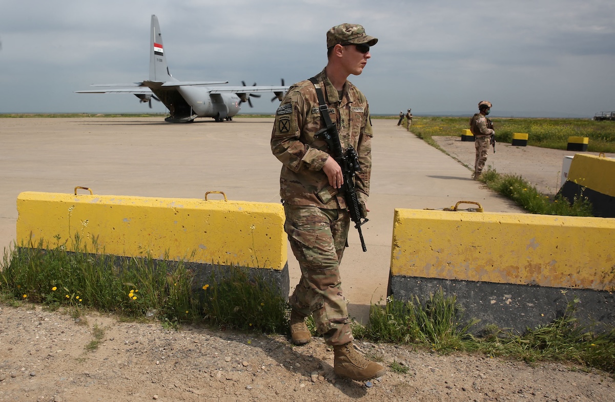 A US soldier walks at the Qayyarah air base, where US-led troops in 2017 had helped Iraqis plan out the fight against the Islamic State in nearby Mosul in northern Iraq, before a planned US pullout on March 26, 2020. (FILE/AFP)