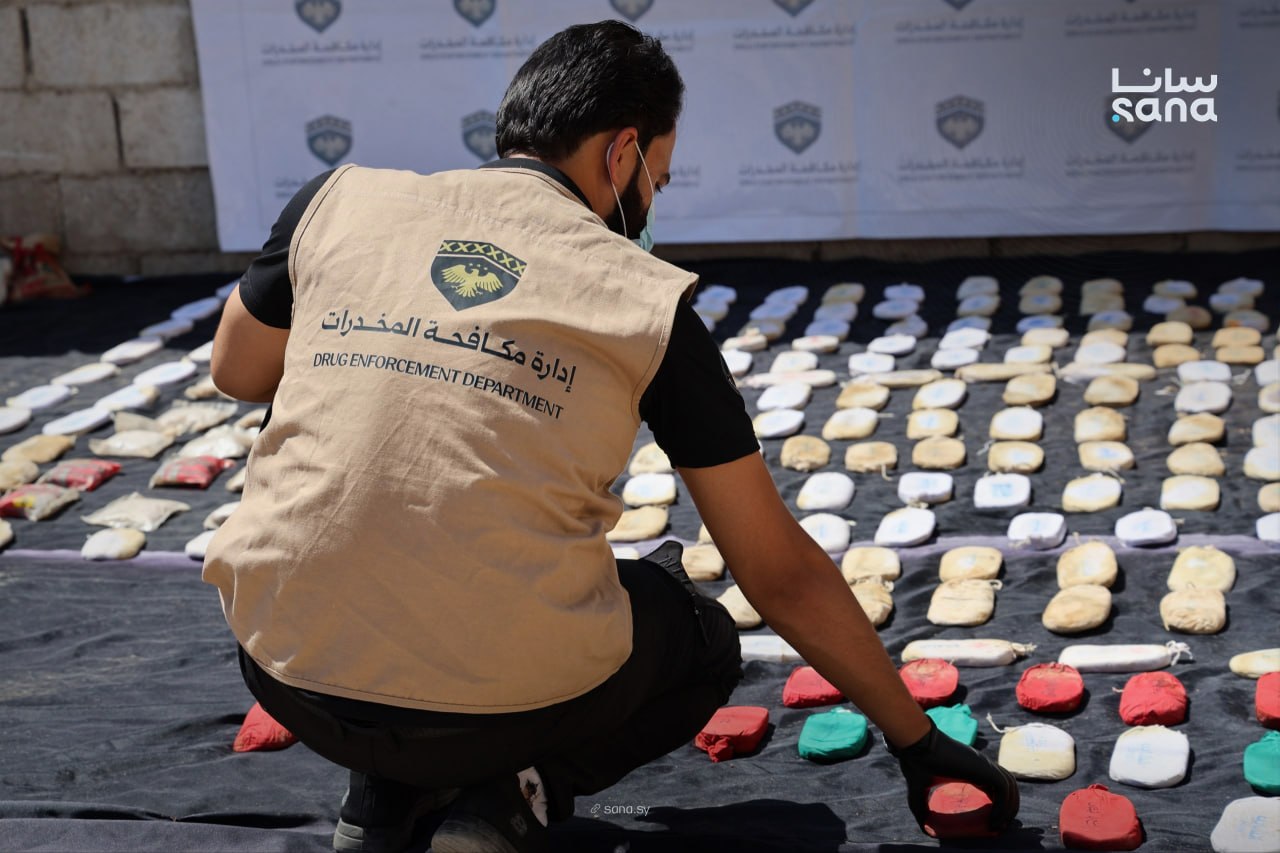A member of the Drug Enforcement Department inspects seized narcotics during an operation in Syria. (SANA)