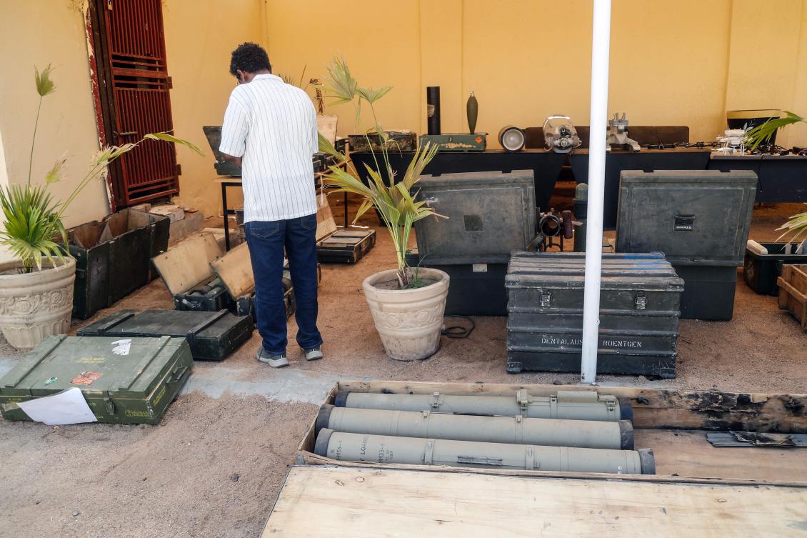 A journalist looks at weapons reportedly seized by the Sudanese army, which it says were supplied to the Rapid Support Forces (RSF) by foreign countries, during a media display in Khartoum, Jul. 16, 2026. (AFP)
