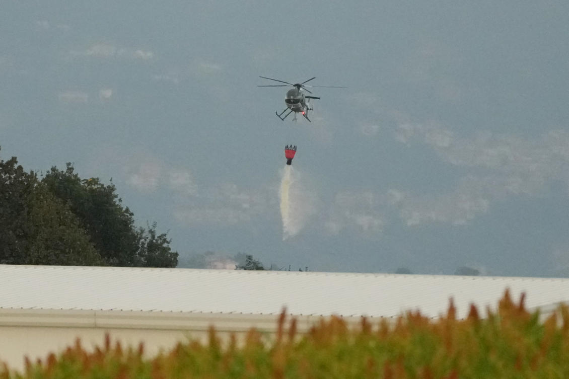 A helicopter drops water over the scene of an explosion at an ammunition plant in Colleferro, near Rome, Aug. 13, 2026. (AP)