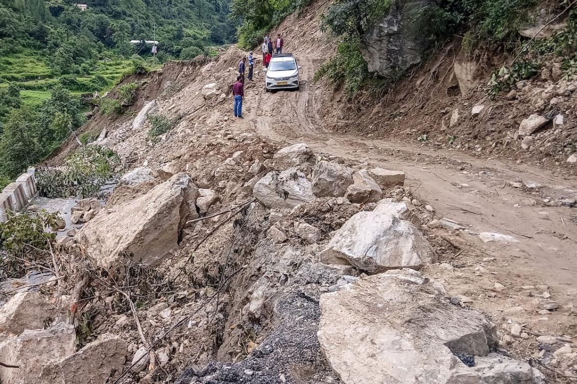 Accidents on large construction sites are common in India, but ecologists say excessive development projects have led to more disasters in the fragile Himalayan areas including Uttarakhand. Above, a car moves along a washed-out road laden with rocks and debris at Bhatwari village in Uttarakhand state on Aug. 8, 2025. (AFP file photo)
