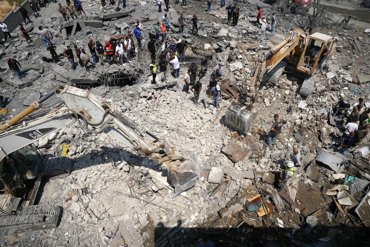 Heavy machinery, first aid responders and residents search the site of an Israeli airstrike that targeted a neighbourhood in the southern Lebanese village of Deir al-Zahrani on August 15, 2026. (FILE/AFP)