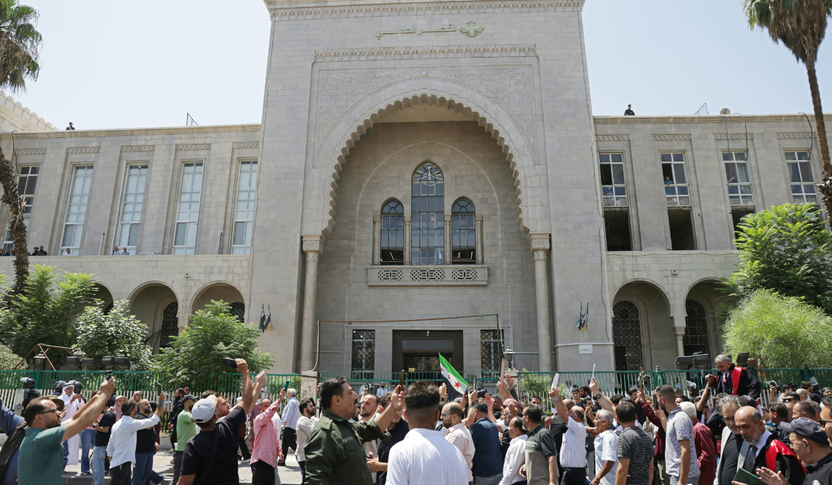 Syrians gather as they celebrate in front of the Palace of Justice after the court proceedings, in Damascus on August 11, 2026. (AFP)