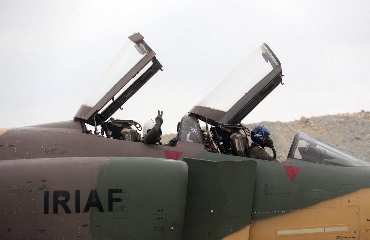 Iranian army pilots gesturing upon landing at Iran's first underground military air base in an undisclosed location. (AFP)