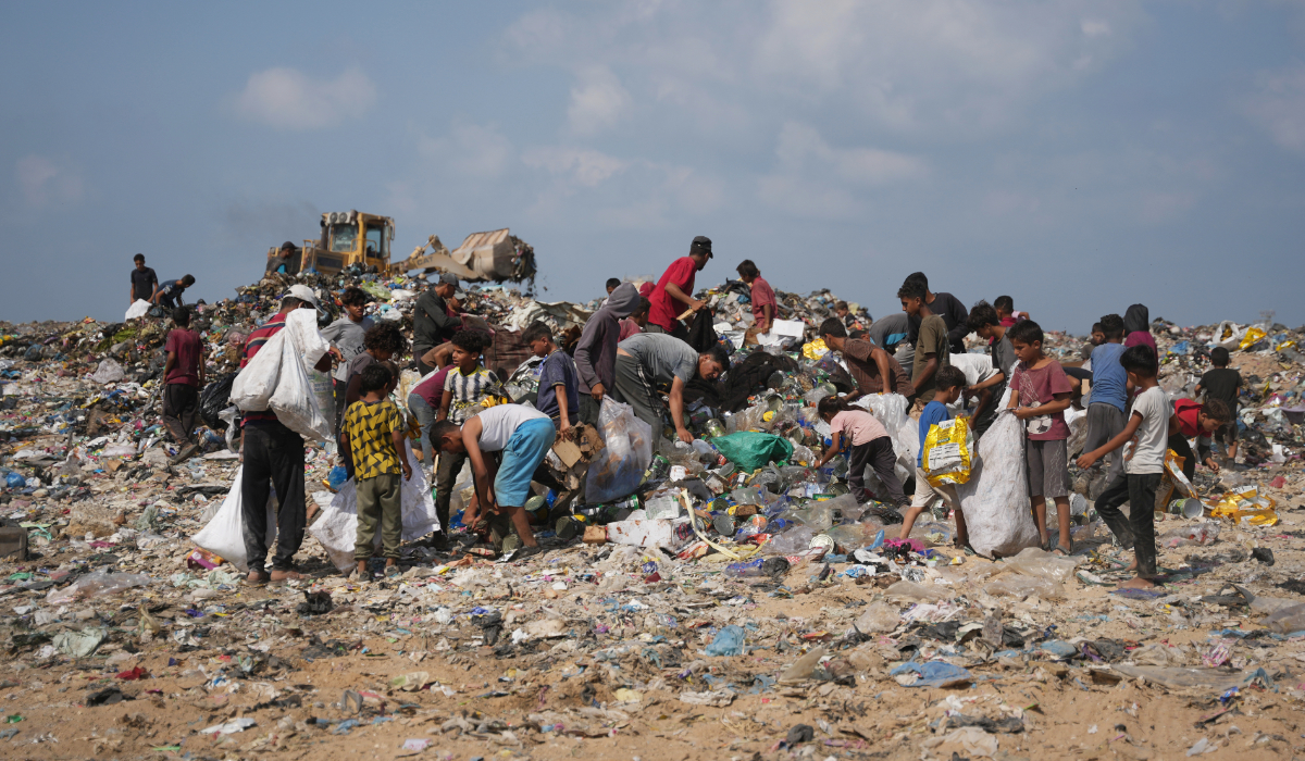 Palestinians search through a garbage dump for combustible materials to use as fuel for cooking due to a shortage of cooking gas, in Deir al-Balah, central Gaza Strip, Saturday, Aug. 22, 2026. (AP)