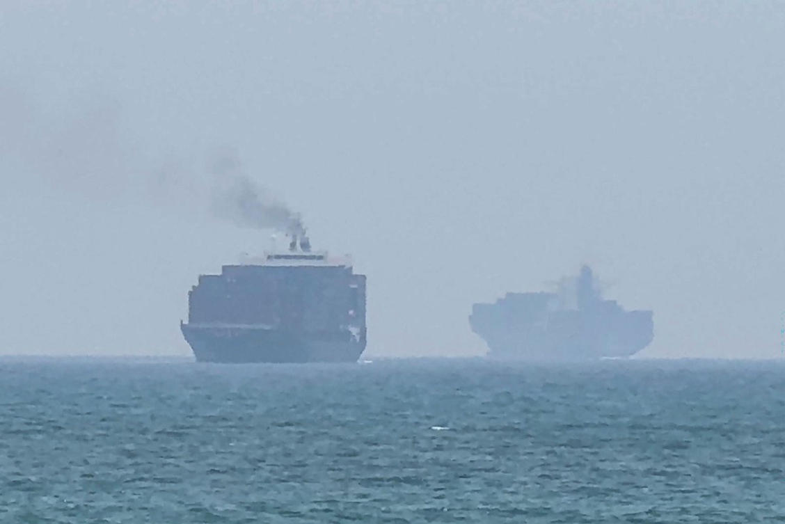This frame grab taken from AFPTV video footage on July 12, 2026 shows cargo ships anchoring near the Strait of Hormuz off the eastern coast of the United Arab Emirates at Khor Fakkan. (AFP file photo)