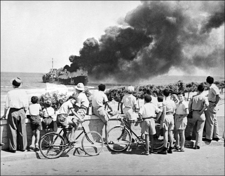 Above, the Altalena burns near Tel Aviv beach on June 27, 1948 after Israeli forces opened fire on the ship on the orders of David Ben Gurion, Israel’s first prime minister. (AFP file photo)