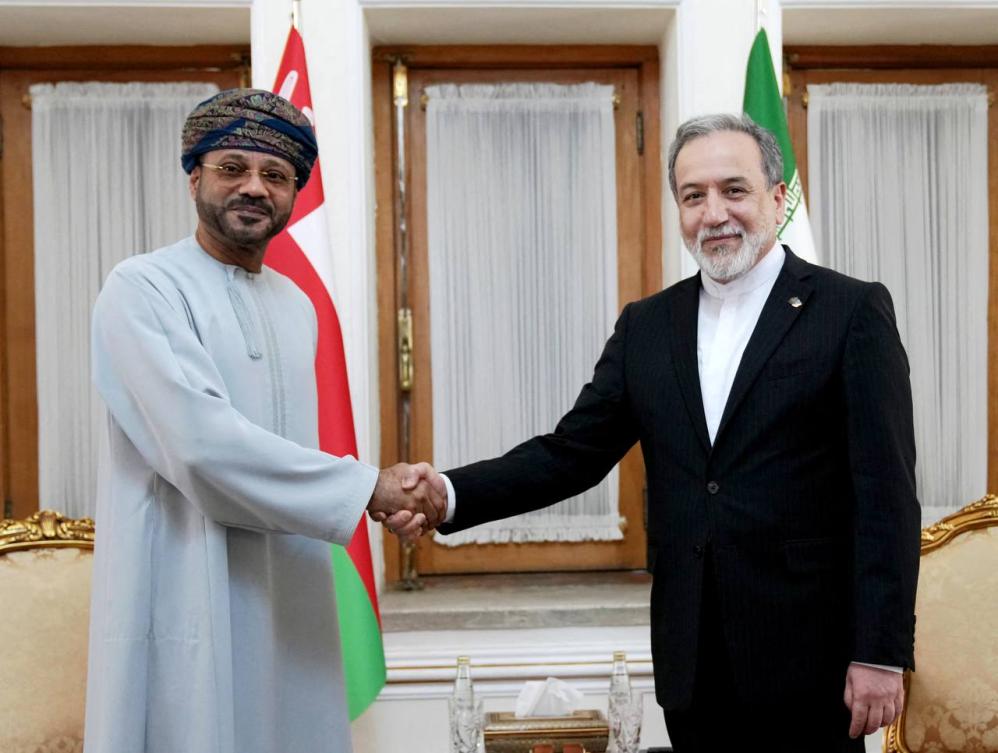 Iranian Foreign Minister Abbas Araghchi, right, with his Omani counterpart Sayyid Badr Al-Busaidi in Tehran on Aug. 25, 2026, as Tehran and Muscat seek a way to regulate the passage of ships through the Strait of Hormuz. (Iranian Foreign Ministry Office/AFP)
