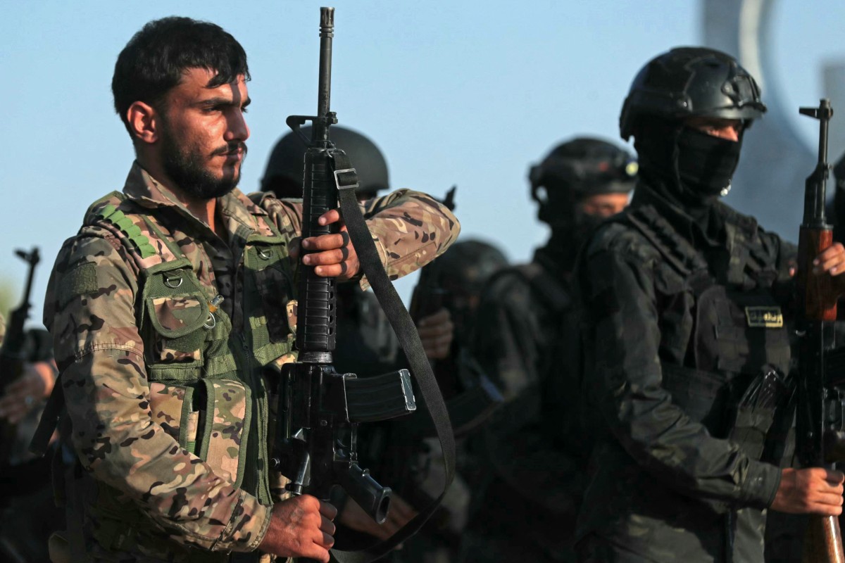 Kurdish fighters from the Qamishli Brigade, part of the Syrian Democratic Forces (SDF) participate in a military parade in Qamishli on August 21, 2026. (File/AFP)